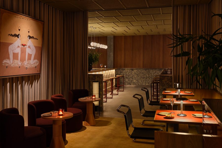 The stylish interior of Bar Bon Funk in Singapore, with low chairs, tables, plants and wall art.